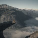 person sitting on the edge of Trolltunga