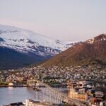 the city of Tromsø, Norway, with snow capped mountains in the background