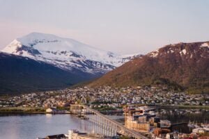 the city of Tromsø, Norway, with snow capped mountains in the background